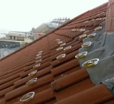 Small bowls of Optical Bird Gel on a tiled roof.