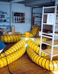 Heat exchangers and insulated pipes in a room.